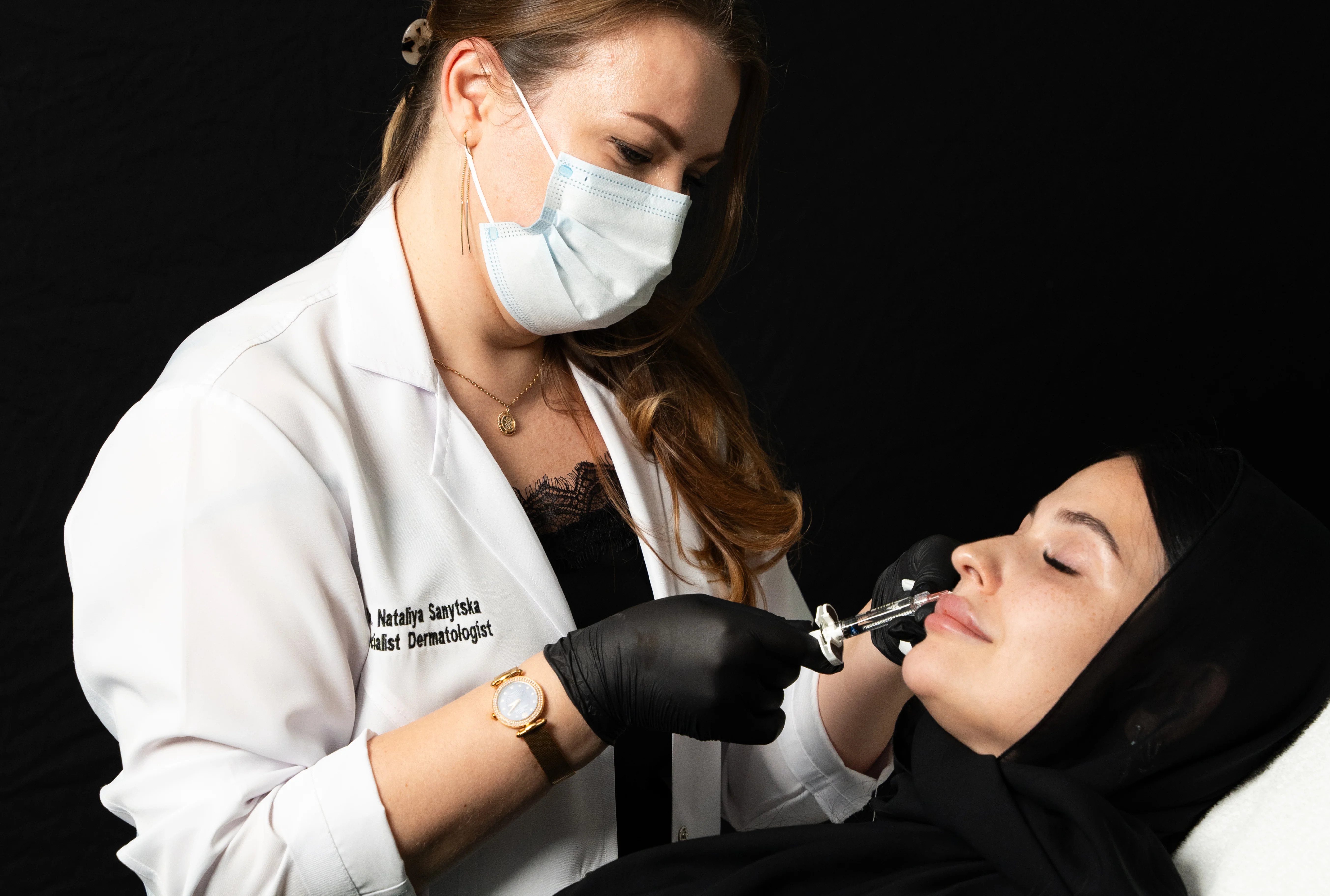 a doctor gives injections to a patient